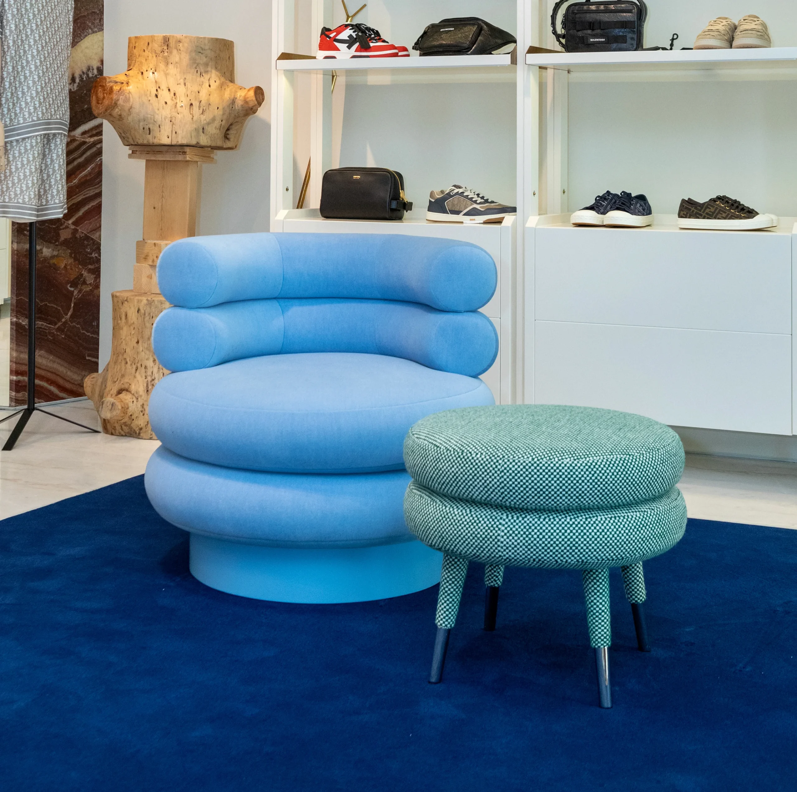 Low Marshmallow Stool with two fully upholstered cylindrical rolls, brass ring accent, and playful sculptural design for modern interiors and luxury living spaces.