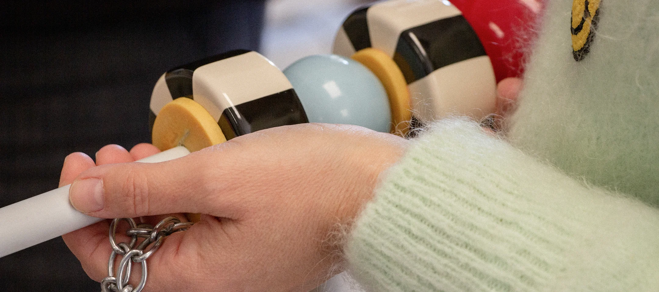 Alice Ceiling Lamp with sculptural brass structure, delicate porcelain accents, and luxurious fabric lampshade, casting warm light in elegant interiors.