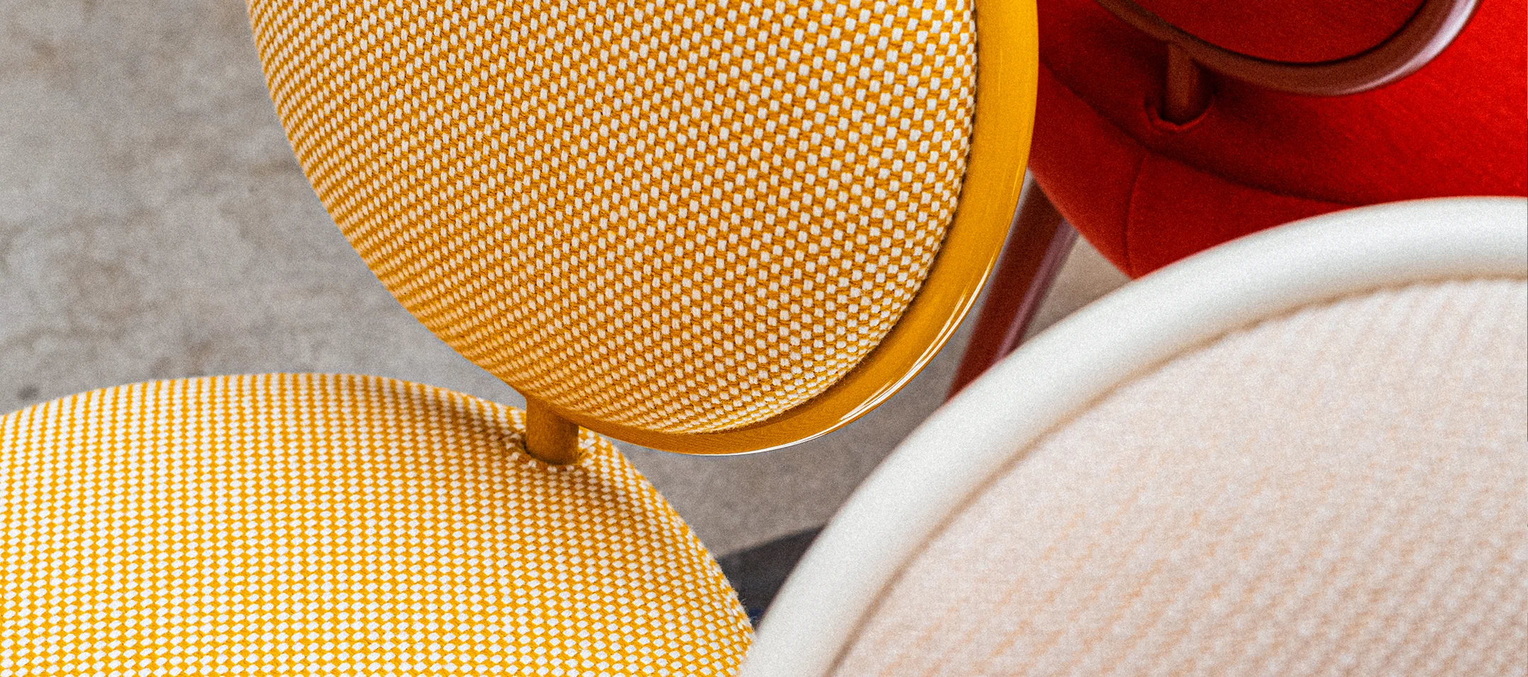 Graceful Chair with rounded upholstered seat and backrest, brass cylinder detail, and lacquered or upholstered legs for luxury interior design