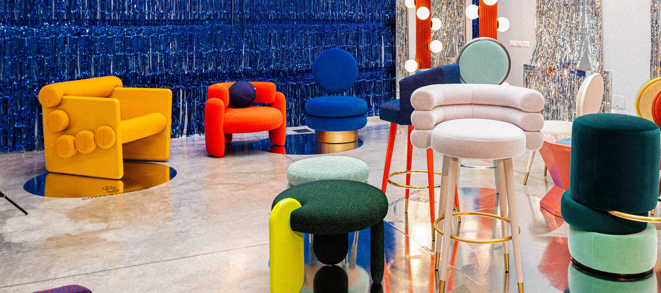 Charles Armchair with classic silhouette, two lacquered side legs, five upholstered rolls for seat and backrest, covered in premium fabrics, a statement piece for modern and high-end interiors