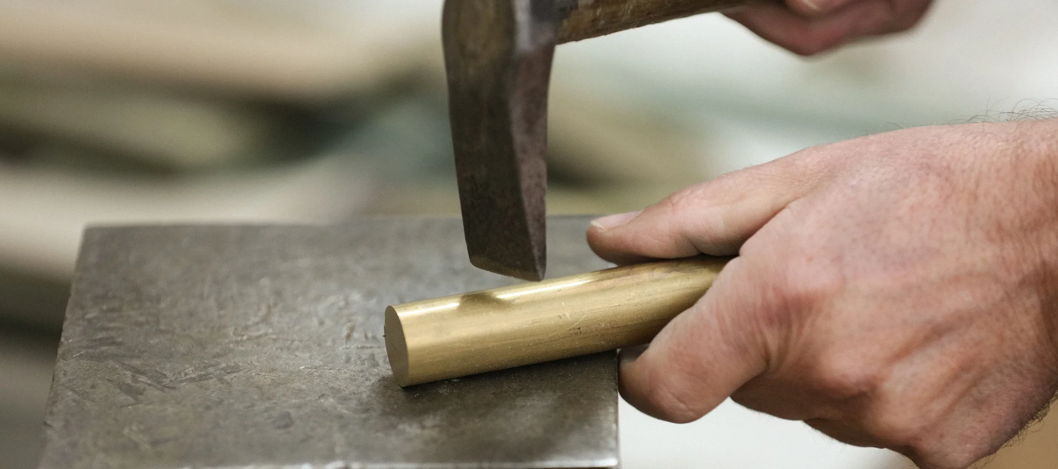 Laura Wall Lamp with crescent-shaped brass design and two upward-facing opal white cylindrical bulbs, elegant lighting for luxury interiors.