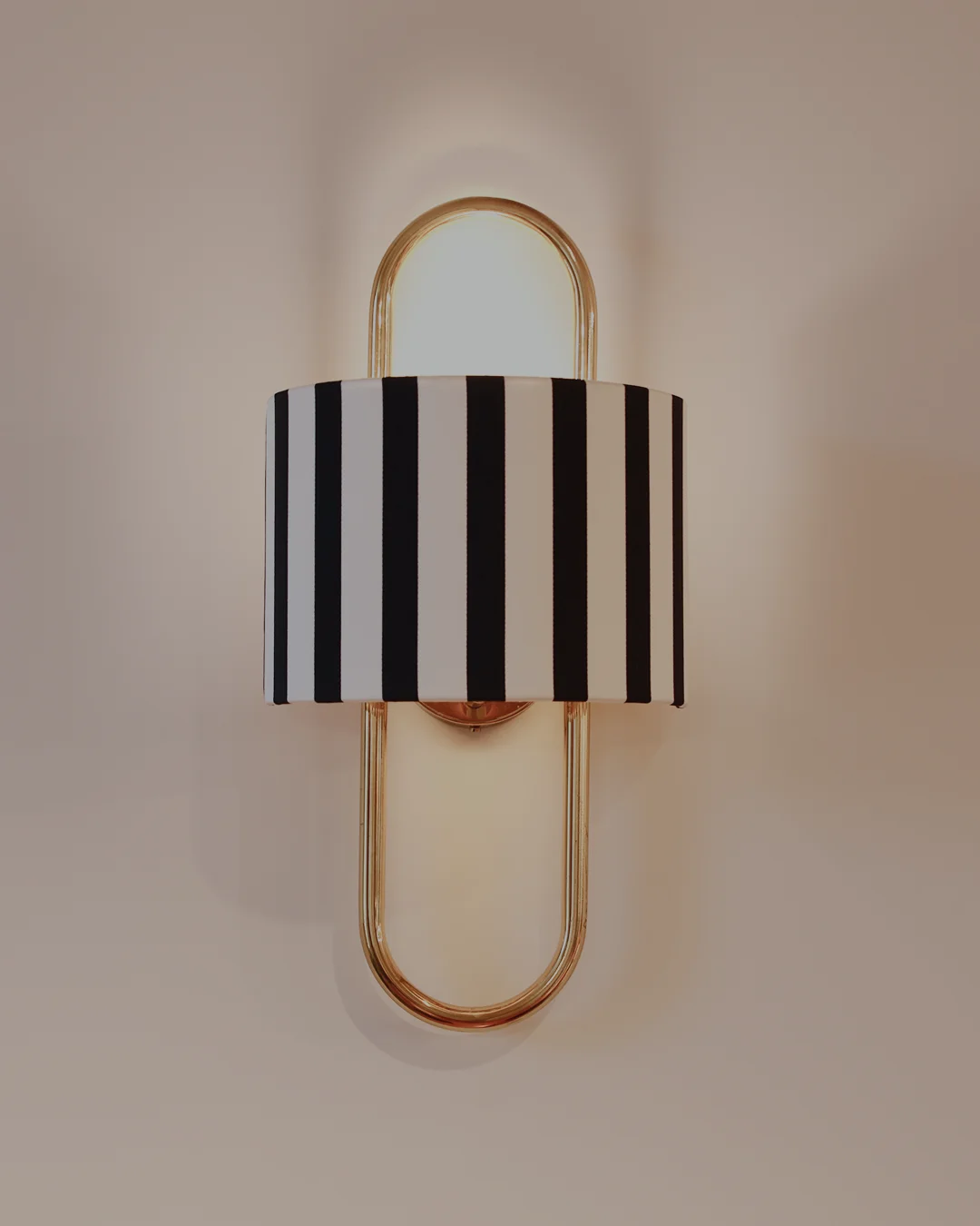Maria Wall Lamp with high-quality brass curved body and premium fabric lampshade, providing soft illumination for sophisticated and luxury interiors.