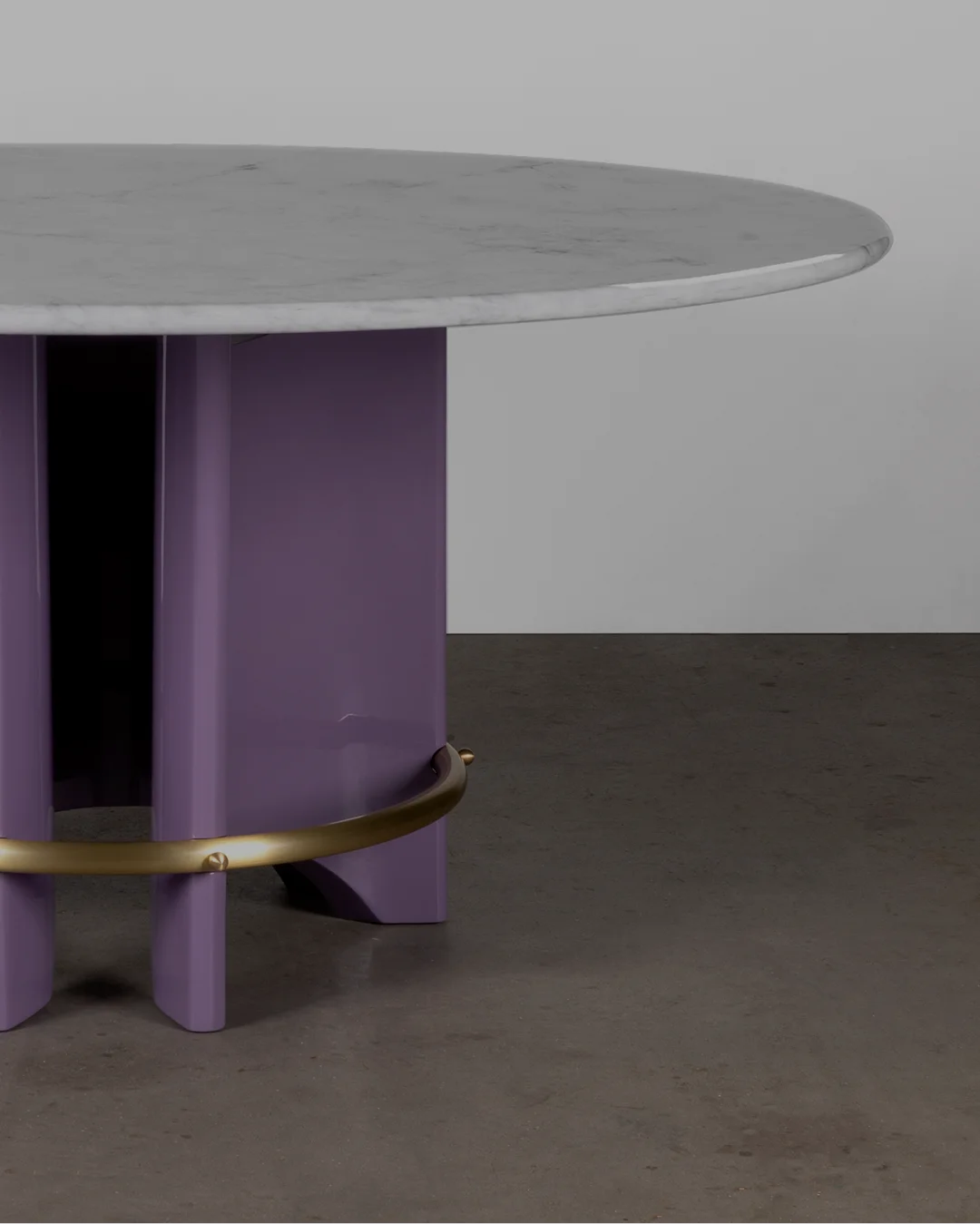 Meyer Dining Table with circular marble top, sculptural lacquered base, brass ring, and exposed screws, handcrafted designer furniture for modern luxury interiors