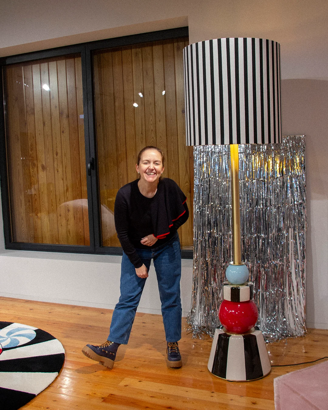 Architectural lighting from the MAAM collection by Royal Stranger, featuring the Valentina floor lamp with its brushed brass structure and hand-applied striped porcelain.