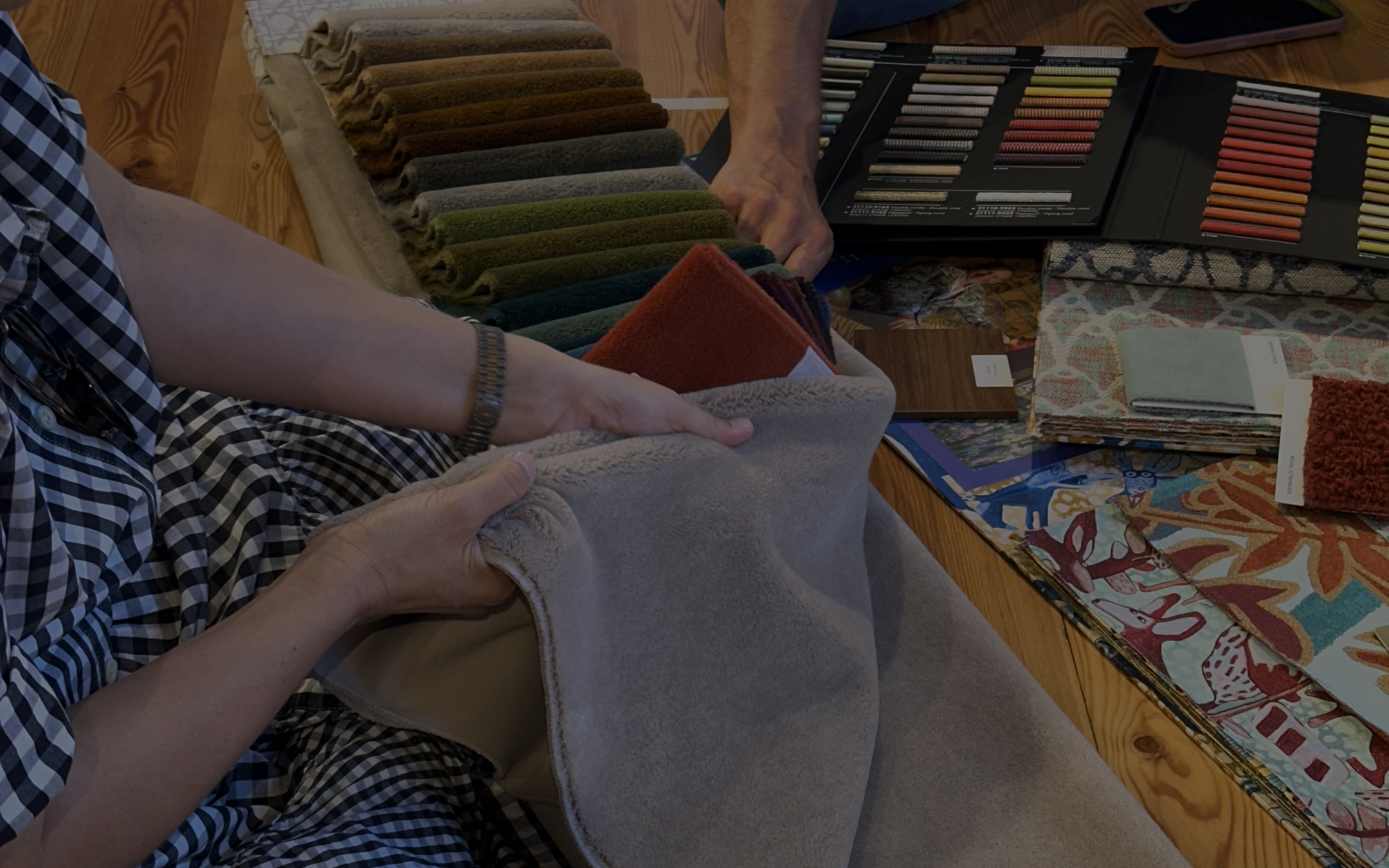 Close-up of upholstery fabrics in different textures and tones, including bouclé, velvet and textured weaves.